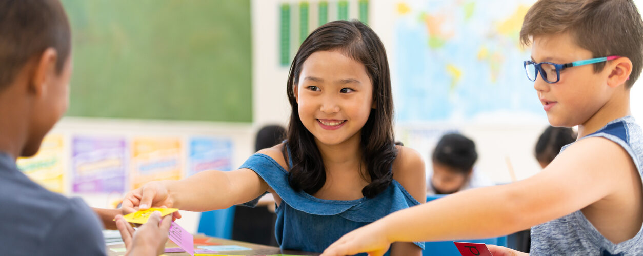 A group of diverse students are sitting in their classroom while working on science projects.